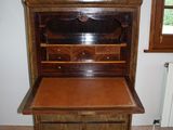a wooden desk with a drawer underneath it in a room