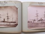 an old photo of two ships in a book on a table