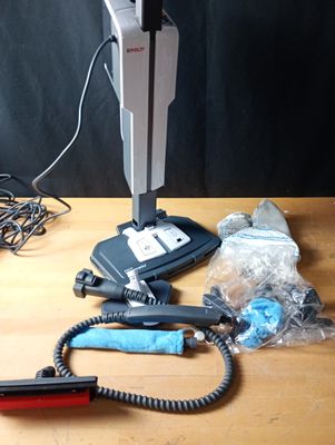 a vacuum that is sitting on a table next to other items