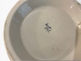 a close up of a white bowl with a blue design on it