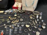 many different types of jewelry on display on a table