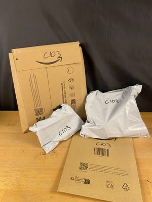 two bags of food sitting on a table next to a cardboard box