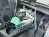 a car dashboard with a bunch of items in it