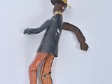 a figurine of a man in a top hat and orange pants