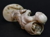 a figurine of a man laying down on a black surface