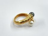 an image of a gold ring with a pearl on top of it