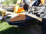 a tractor that is parked in the grass