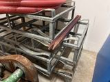 a stack of metal racks with red hoses on top of them