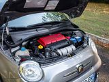a small silver car with a red battery in the hood