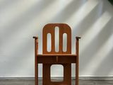 a wooden chair that is sitting in front of a stair
