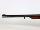 a rifle with a wooden barrel on a white background