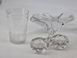 a glass vase and a glass cup on a table