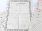 some old papers are sitting on a table with a pen and paper