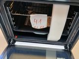 a toaster oven with a note taped to the door