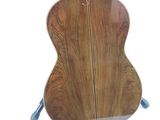 a guitar that is sitting on a stand on a white background
