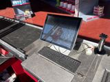 a laptop computer sitting on top of a metal table