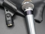 two microphones on a black surface with a leather case