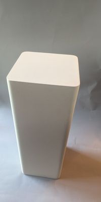 a white vase that is sitting on a table