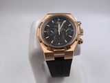 an image of a black and gold watch on a white stand