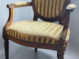 an image of a wooden chair with a striped upholstered seat