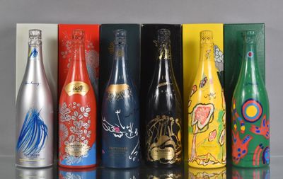 bottles of different types and colors are lined up on a table