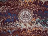 a picture of a marbled wall with a cross on it
