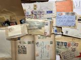 a pile of old letters and envelopes sitting on top of a table