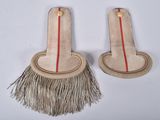 two pieces of wood with a long handle and a red stripe