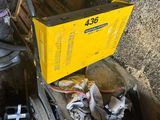 a yellow box sitting on top of a pile of junk