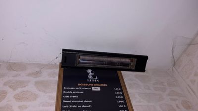 a menu on the floor next to a wall