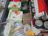 a box full of assorted items sitting on the ground