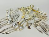 a lot of silver spoons and forks on the table