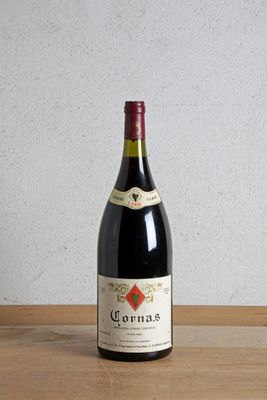 a bottle of wine sitting on a table next to a bottle of wine