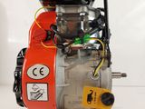 an orange and black engine sitting on top of a white table