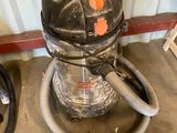 a vacuum and a hose in a room
