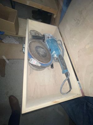 a box with a tool inside of it on the floor