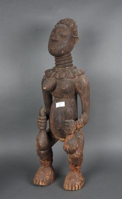 une statue en bois représentant une femme tenant un bébé dans ses bras