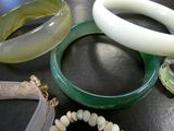 a lot of different bracelets and bangles on a table