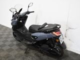 a motorcycle that is parked in a room with a checkered floor