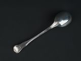 a spoon that is sitting on a black surface