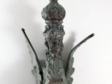 bronze statue of a bird with a crown on it ' s head