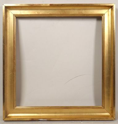 a gold picture frame on a white wall with a white background