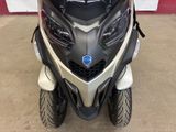 a black and white motorcycle parked in a garage