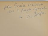 an old book with a handwritten message on it sitting on a table