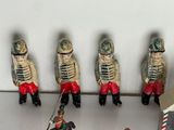 several figurines of soldiers on a shelf in a room