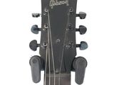 a close up of the headstock of an acoustic guitar