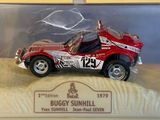 a red toy car in a clear case on a table