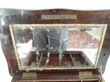 a small wooden box with a mirror on top of it