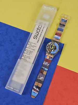 a watch that is sitting on a blue and yellow surface
