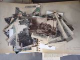 a pile of old photos on top of an open book
